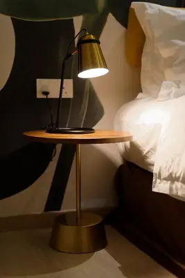 a lamp on a table next to a bed at Sojourn Spa Hotel Ipoh in Ipoh