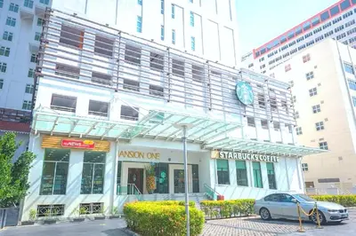 a building with a car parked in front of it at Mansion One, Private Room in George Town