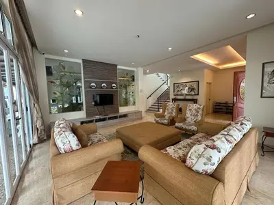 a living room with two couches and a television at Dear Dino House in Tanah Rata