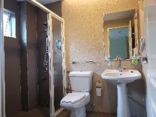 a bathroom with a toilet and a sink at Dear Dino House in Tanah Rata