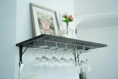 a hanging wine glass rack with wine glasses at Smell rose beach garden in Batu Ferringhi