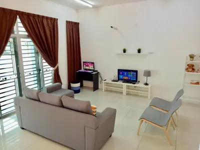 a living room with a couch and a tv at Kampar Sakura 3 Landed in Kampar