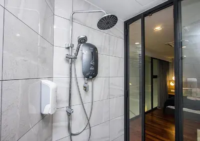 a bathroom with a shower with a phone on the wall at Rumahku Gurney with 270 degree Sea View in George Town