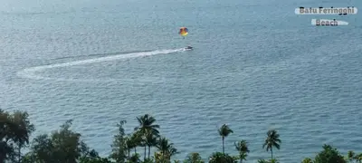 a person flying a kite in the water at Rumahku Gurney with 270 degree Sea View in George Town