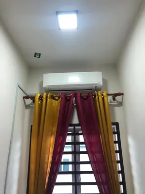 a window with colorful curtains in a room at Hasnifana Homestay Seri Iskandar in Seri Iskandar