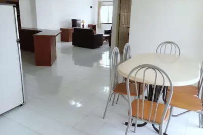 a kitchen and dining room with a table and chairs at Dindings Pantai Desair Apartment By DPD in Lumut