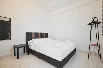 a bedroom with a bed and a tripod next to it at Ipoh Garden Homestay in Ipoh