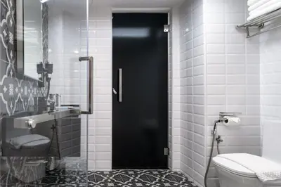 a black door in a bathroom with a toilet at Loop On Leith George Town Penang Hotel in George Town