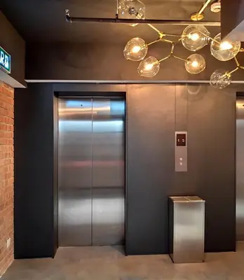 an elevator in a building with silver doors and lights at Loop On Leith George Town Penang Hotel in George Town