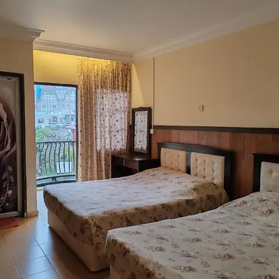 a hotel room with two beds and a balcony at Super Budget 3 Rooms Apartment @ Brinchang Town in Brinchang