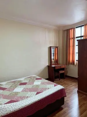 a bedroom with a bed and a dresser and a desk at Super Budget 3 Rooms Apartment @ Brinchang Town in Brinchang
