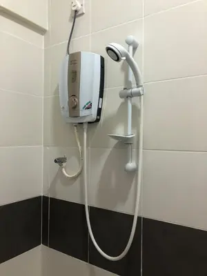 a shower in a bathroom with a hand dryer on a wall at Super Budget 3 Rooms Apartment @ Brinchang Town in Brinchang