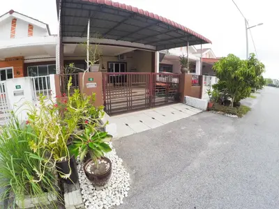 a house with a gate and plants in front of it at D HOMESTAY SERI ISKANDAR in Seri Iskandar