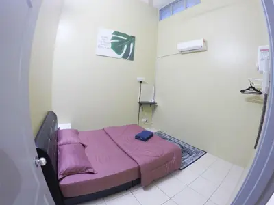 a small bedroom with a purple bed in a room at D HOMESTAY SERI ISKANDAR in Seri Iskandar