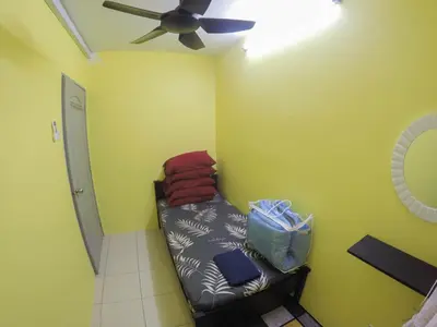 a room with a couch and a ceiling fan at D HOMESTAY SERI ISKANDAR in Seri Iskandar