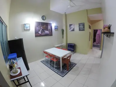 a living room with a table and a room with aifferenceperture at D HOMESTAY SERI ISKANDAR in Seri Iskandar