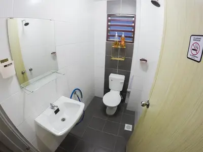 a bathroom with a white toilet and a sink at D HOMESTAY SERI ISKANDAR in Seri Iskandar