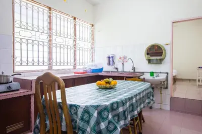 a kitchen with a table with a bowl of fruit on it at Sweet Home With 2 Auto Gates at BM, Penang, M'sia in Bukit Mertajam