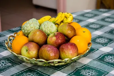 a bowl of fruit sitting on a table at Sweet Home With 2 Auto Gates at BM, Penang, M'sia in Bukit Mertajam