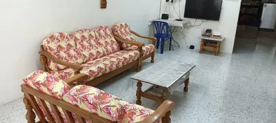 a living room with a couch and a coffee table at Sweet Home With 2 Auto Gates at BM, Penang, M'sia in Bukit Mertajam