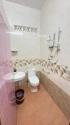 a bathroom with a toilet and a sink at Sweet Home With 2 Auto Gates at BM, Penang, M'sia in Bukit Mertajam