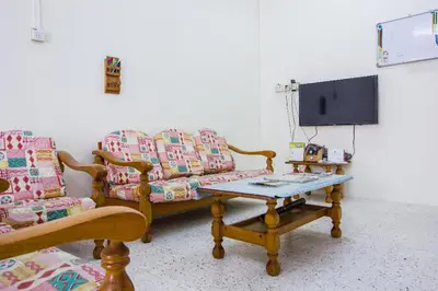 a living room with a couch and a table at Sweet Home With 2 Auto Gates at BM, Penang, M'sia in Bukit Mertajam