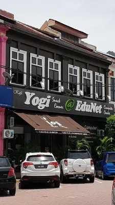 two cars parked in a parking lot in front of a building at Rooms only @KKB in Kuala Kubu Baharu