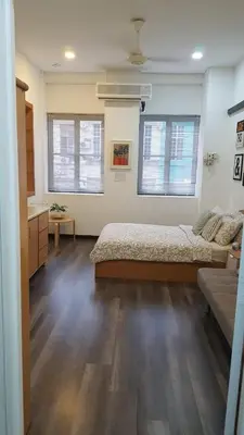 a bedroom with a bed and two windows at Rooms only @KKB in Kuala Kubu Baharu