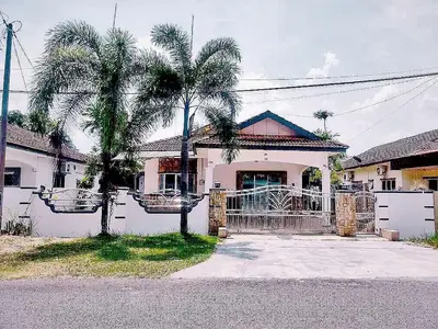 a house with two palm trees in front of it at Taiping Vacation Home in Taiping