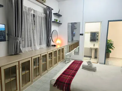 a bathroom with a bed and a sink and a mirror at Taiping Vacation Home in Taiping