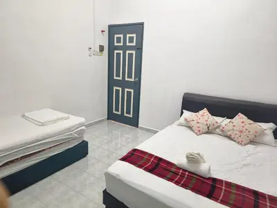 a bedroom with a bed with two pillows on it at Taiping Vacation Home in Taiping