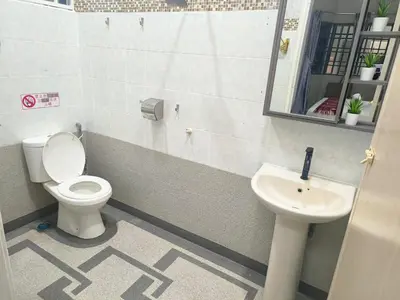 a bathroom with a toilet and a sink at Taiping Vacation Home in Taiping