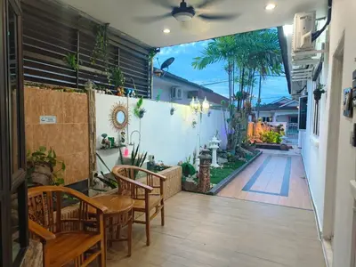 a patio with a table and chairs and a fence at Taiping Vacation Home in Taiping