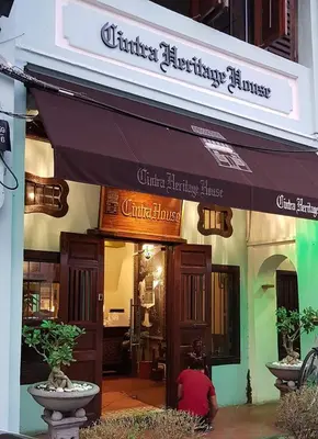 a person is standing outside of a store at Cintra House in George Town