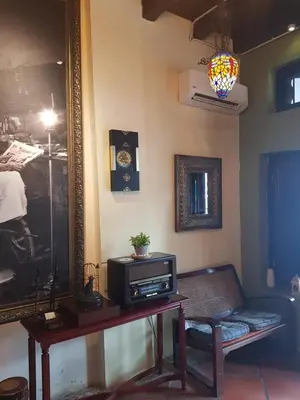 a living room with a tv and a mirror at Cintra House in George Town