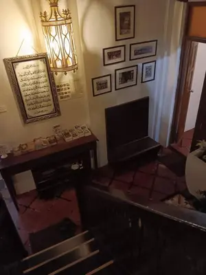 a living room with a piano and a television at Cintra House in George Town