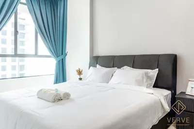 a white bed with a towel on top of it at Lovely Home Casa Kayangan A2207 in Ipoh