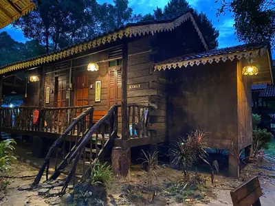 a small wooden house with a porch and a deck at Rustic Chalet - Dahlia n Mawar at Sedim Vista in Kampong Ulu Sedim