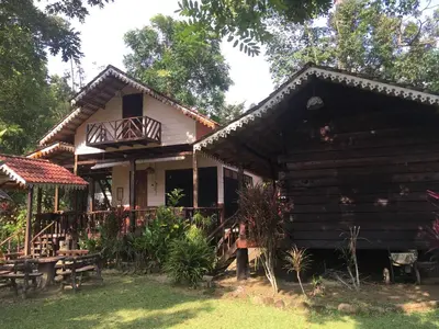 a log house with a porch and a balcony at Rustic Chalet - Dahlia n Mawar at Sedim Vista in Kampong Ulu Sedim