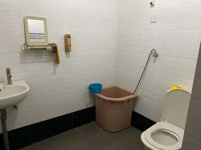 a bathroom with a toilet and a sink at Rustic Chalet - Dahlia n Mawar at Sedim Vista in Kampong Ulu Sedim