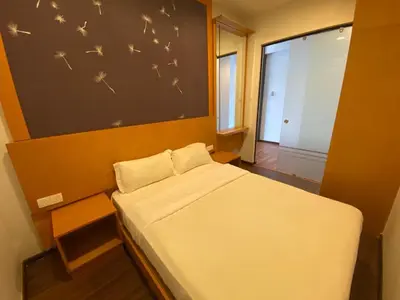 a small bedroom with a bed and a large window at Aranda Nova Suite in Cameron Highlands