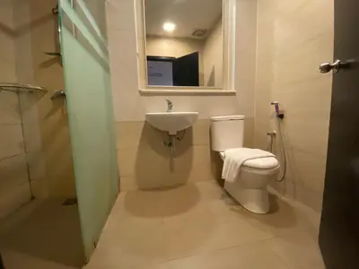 a bathroom with a toilet and a sink and a mirror at Aranda Nova Suite in Cameron Highlands