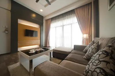 a living room with a couch and a table at Aranda Nova Suite in Cameron Highlands