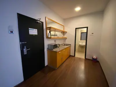 a room with a kitchen with a sink and a toilet at Aranda Nova Suite in Cameron Highlands