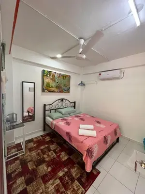 a bedroom with a pink bed and a mirror at MyDusun Chalet, Taiping, Perak, Malaysia in Taiping