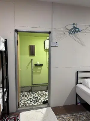 a door leading into a room with a green wall at MyDusun Chalet, Taiping, Perak, Malaysia in Taiping