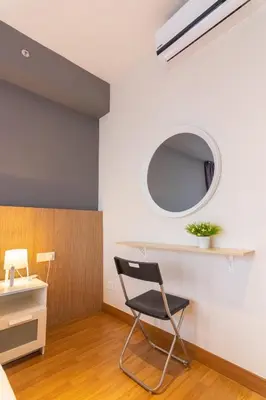 a black chair in a room with a mirror at Georgetown Tropicana 218 by Airlevate Suites in George Town