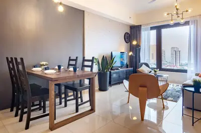 a dining room and living room with a table and chairs at Georgetown Tropicana 218 by Airlevate Suites in George Town