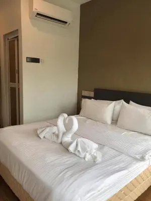 a swan made out of towels on a bed at TT Dorf Hotel Taiping in Taiping