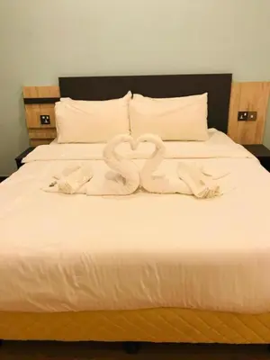 a bed with two swans made out of towels at TT Dorf Hotel Taiping in Taiping